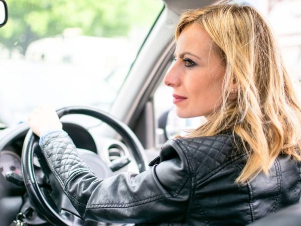 Woman Driving a Black Car