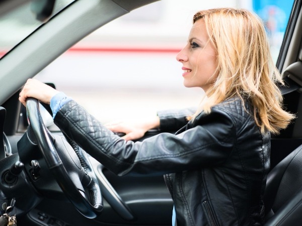 Woman Driving a Black Car