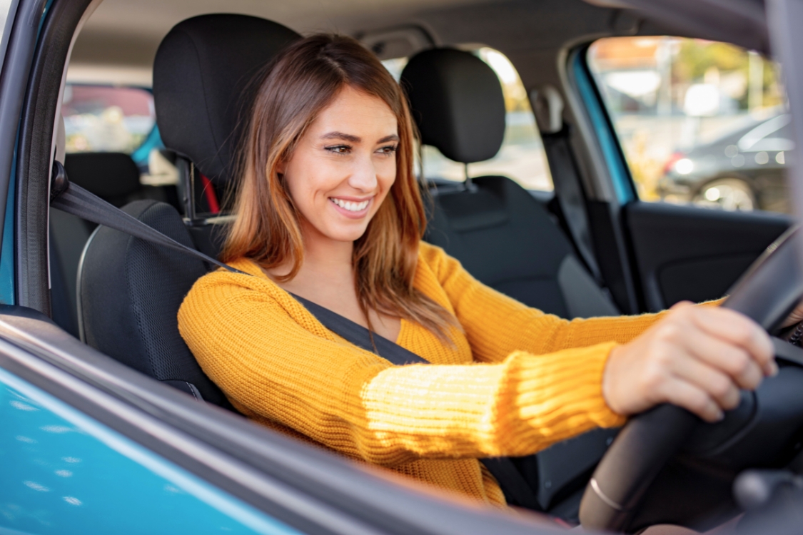 Woman Driving a Blue Car