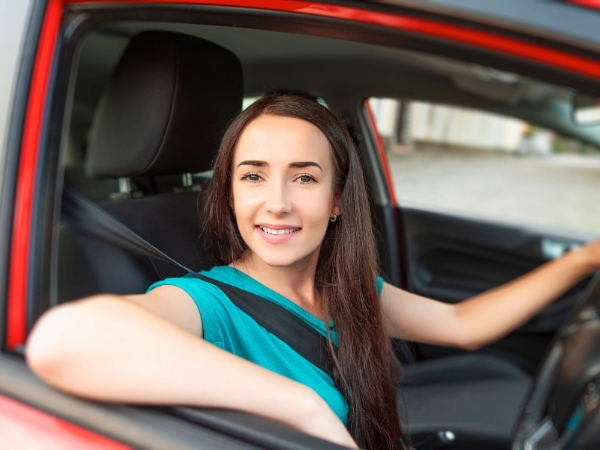 Woman Driving a Red Car