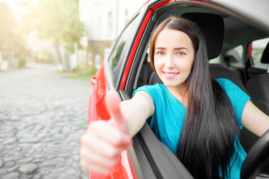 Woman Driving a Red Car